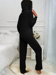 Black ribbed knit hooded loungewear set with long sleeves and pants.
