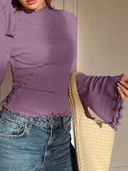 Purple lettuce edge flare sleeve t-shirt with seam detail, styled with jeans and a woven bag.