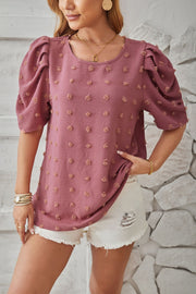 Textured puff-sleeve blouse in Dusty Pink with pom-pom details.