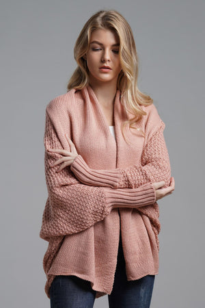 Pink batwing knit cardigan with drape front and textured sleeves.