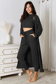 Black loungewear set with crop top, open cardigan, and drawstring pants.