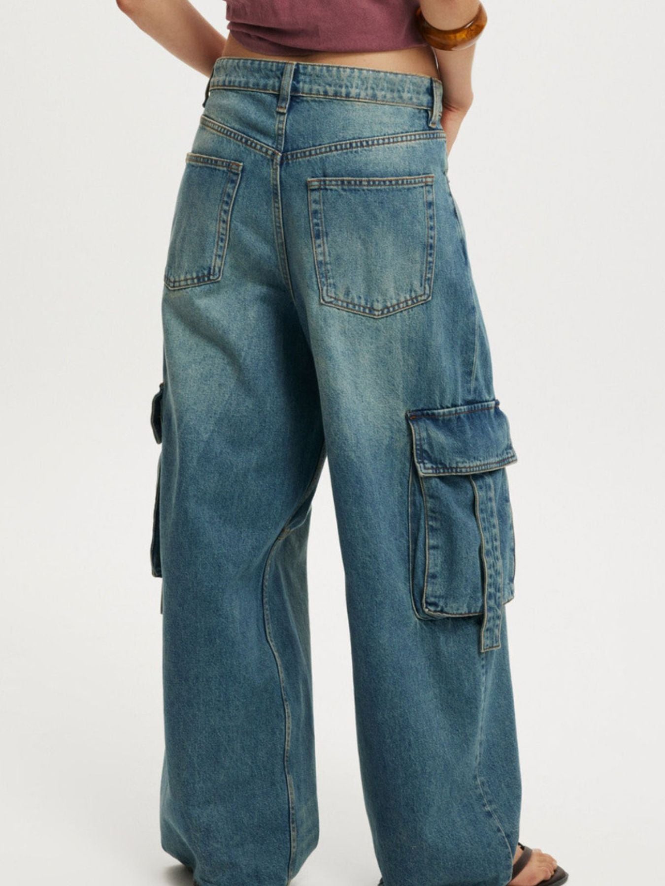 Relaxed fit light blue wash cargo jeans with vintage charm and multiple pockets.