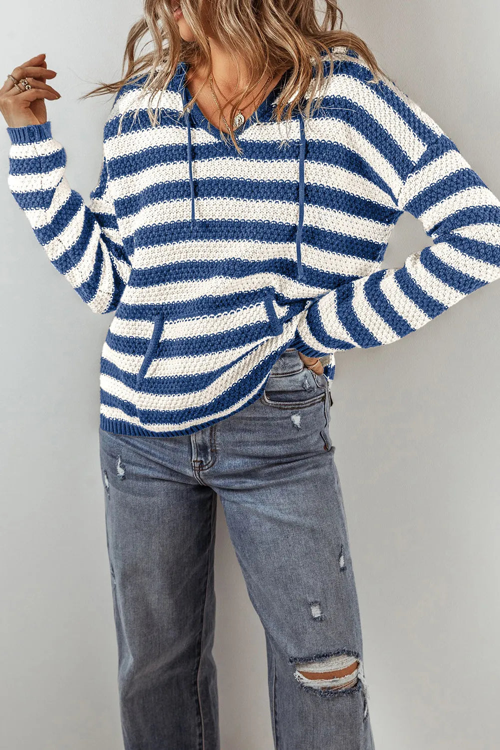 Peacock blue and white striped knit hoodie with adjustable drawstring and pouch pocket.