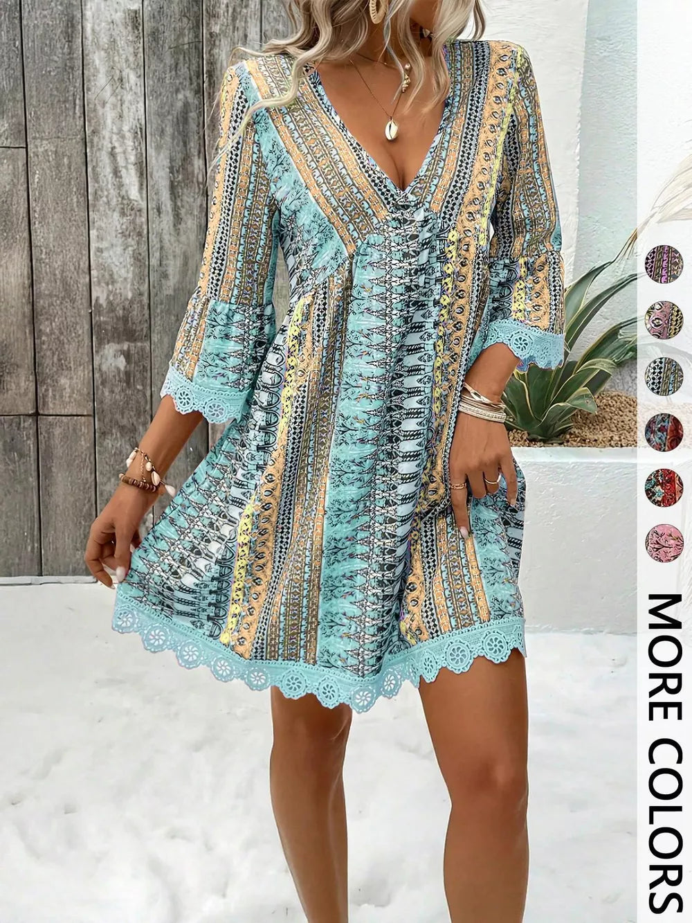 Bohemian printed V-neck dress with bell sleeves and lace trim in blue.