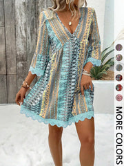 Bohemian printed V-neck dress with bell sleeves and lace trim in blue.