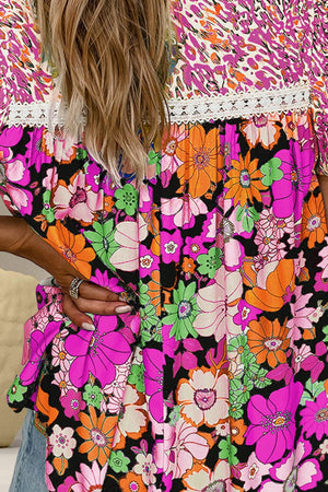 Floral patchwork blouse with puff sleeves and lace trim in vibrant colors.