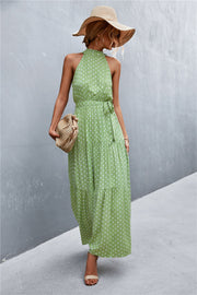 Green polka dot halter maxi dress with tiered skirt and tie waist
