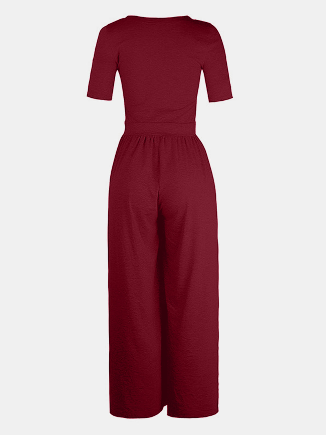 Burgundy textured wide-leg maternity jumpsuit with short sleeves and subtle elastic waist.