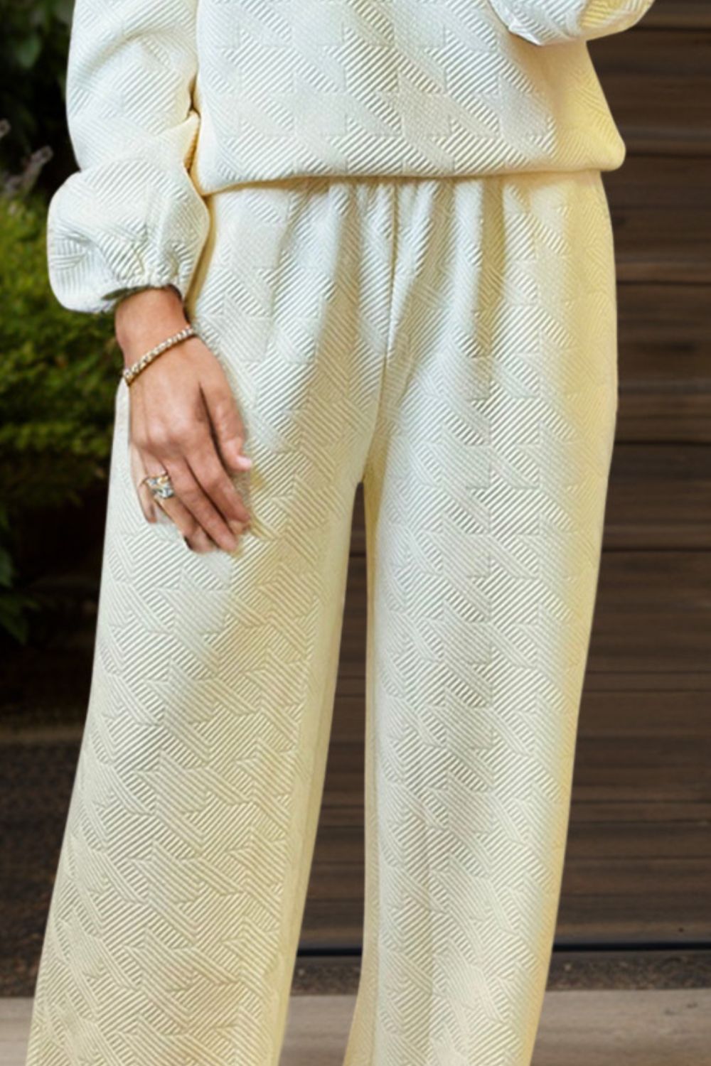 Ivory textured loungewear set with puff sleeves and wide-leg pants.
