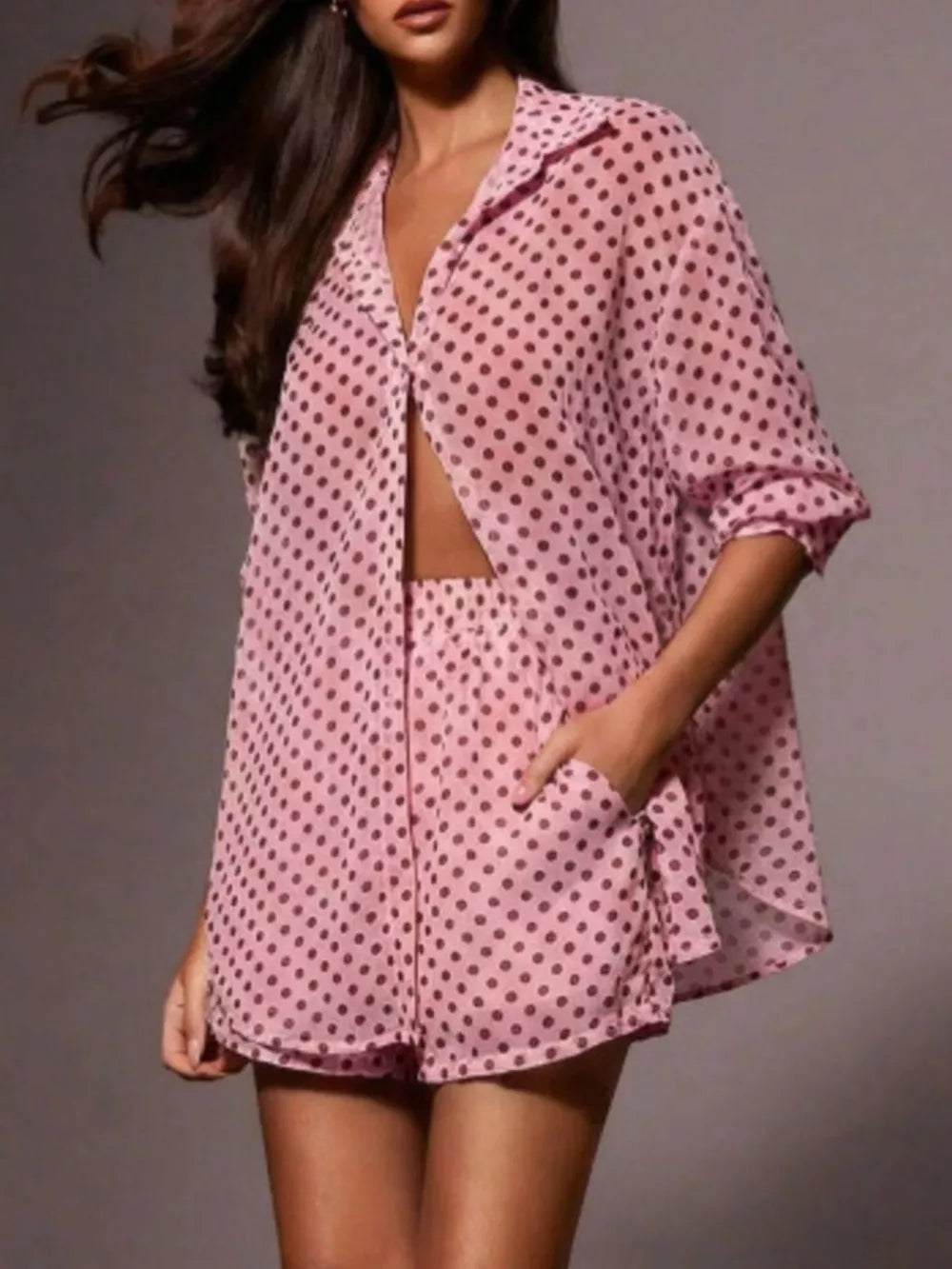 Pink polka dot sheer two-piece set with collared button-up shirt and shorts.