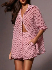 Pink polka dot sheer two-piece set with collared button-up shirt and shorts.