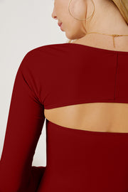 Burgundy long sleeve bodysuit with open back detail and sculpted sleeves.