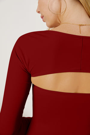 Burgundy long sleeve bodysuit with open back detail and sculpted sleeves.
