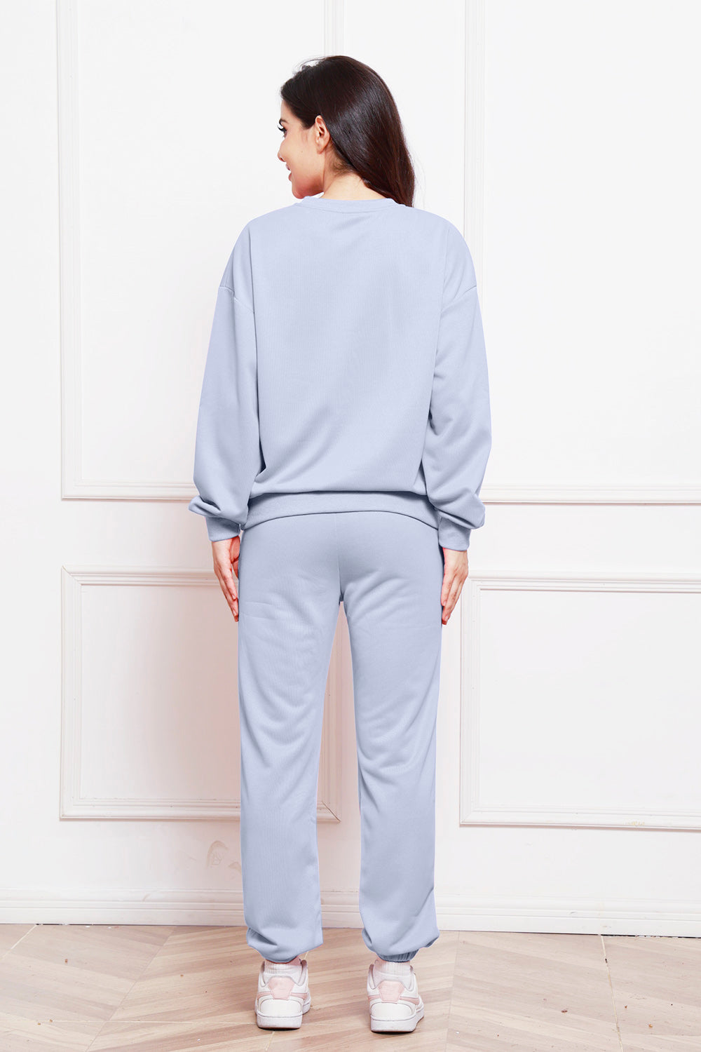 Light blue relaxed fit loungewear set with crewneck sweatshirt and cuffed sweatpants.