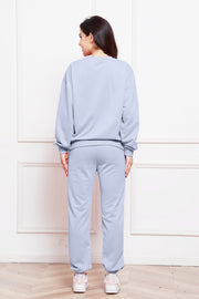 Light blue relaxed fit loungewear set with crewneck sweatshirt and cuffed sweatpants.