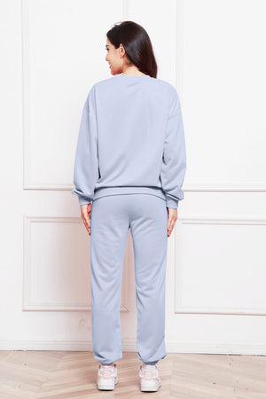 Light blue relaxed fit loungewear set with crewneck sweatshirt and cuffed sweatpants.