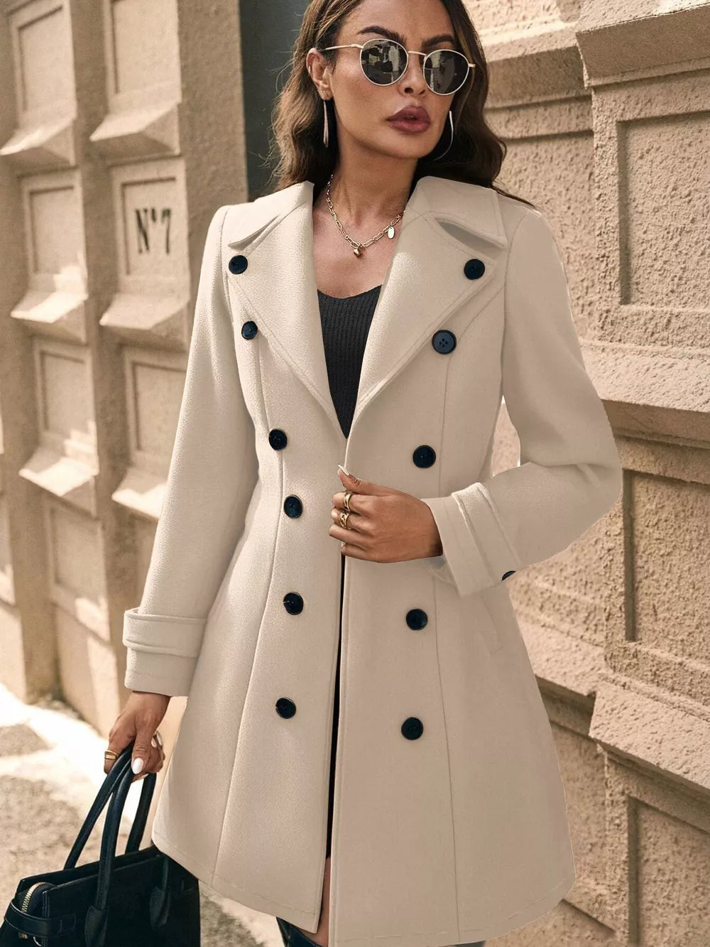 Pale Blush wool blend double-breasted trench coat with cuffed sleeves and dark buttons.