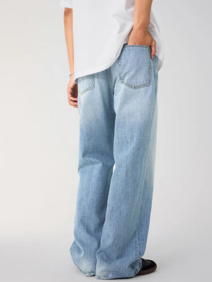 Men's light wash cotton wide-leg jeans with back pockets.