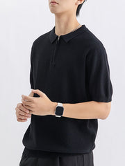 Black textured knit zip-up polo shirt with short sleeves and a spread collar.