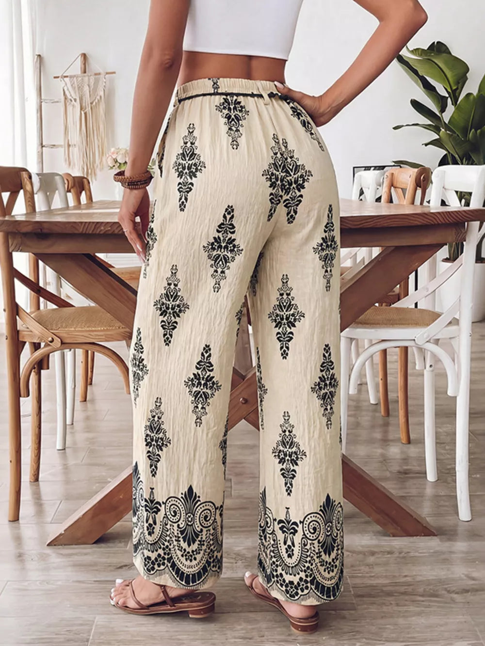 Beige wide leg maternity pants with black boho print and pockets.