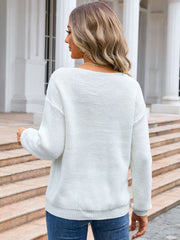 White textured knit sweater with crew neck and long sleeves.
