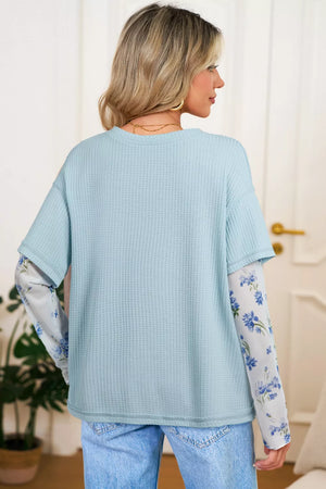 Light blue waffle knit maternity overshirt with floral print mesh sleeves.