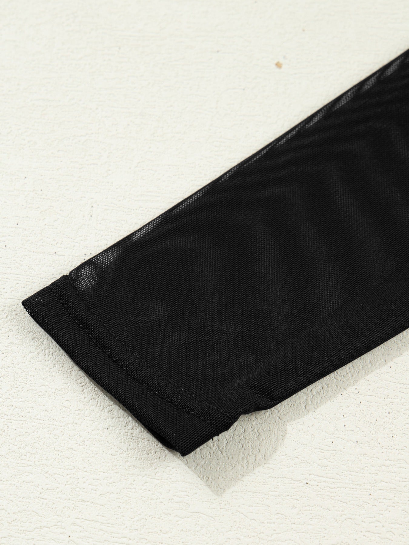 Black sheer mesh maternity shirt sleeve detail with clean hem