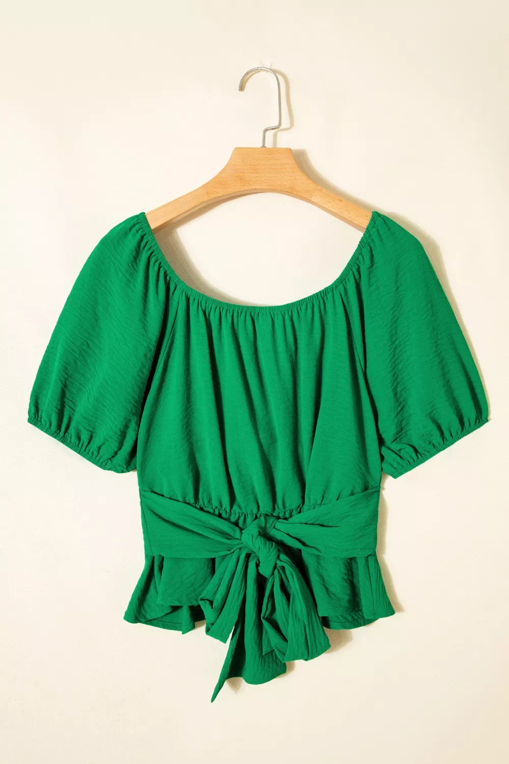 Green ruched crossed waist peplum shirt with puff sleeves and tie front.