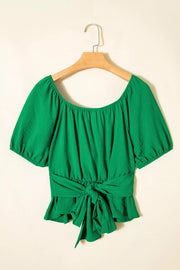 Green ruched crossed waist peplum shirt with puff sleeves and tie front.