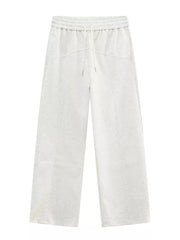 Cream cotton drawstring sweatpants with wide legs and tailored seams.