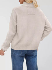 Ivory knit cardigan with ribbed detail on the back yoke and cuffs.