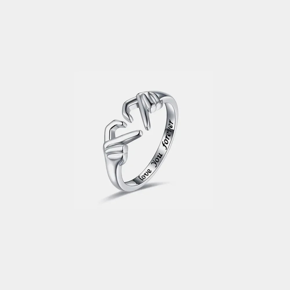 Silver ring with heart hands design and engraved text "love You forever