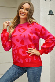 Colorblock leopard knit sweater with balloon sleeves in hot pink and orange-red.