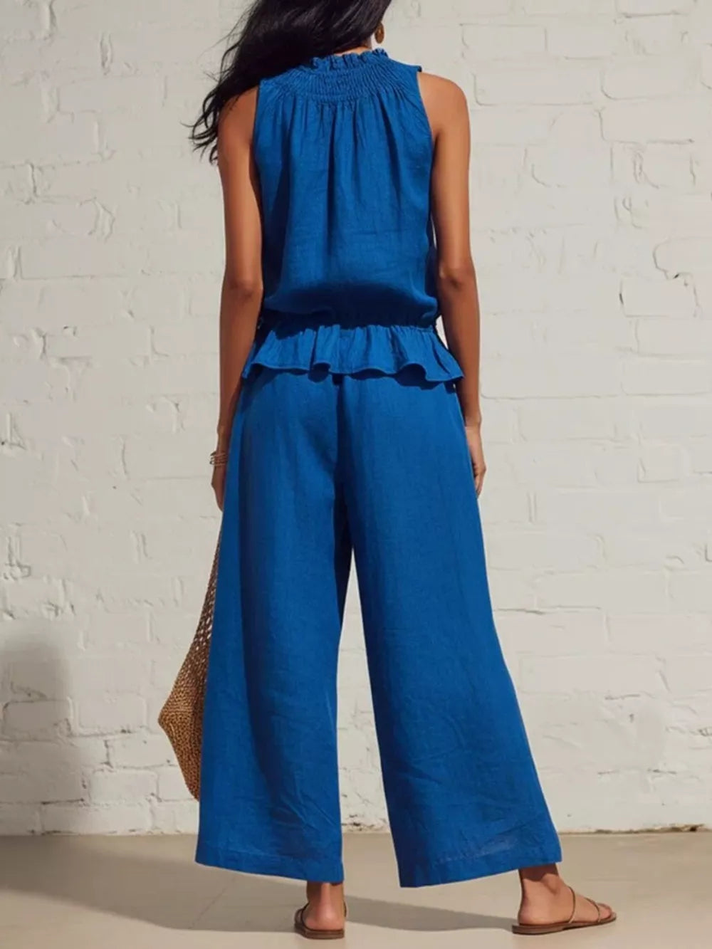 Blue smocked peplum top and flowing wide-leg pants set with ruffled hem detail.