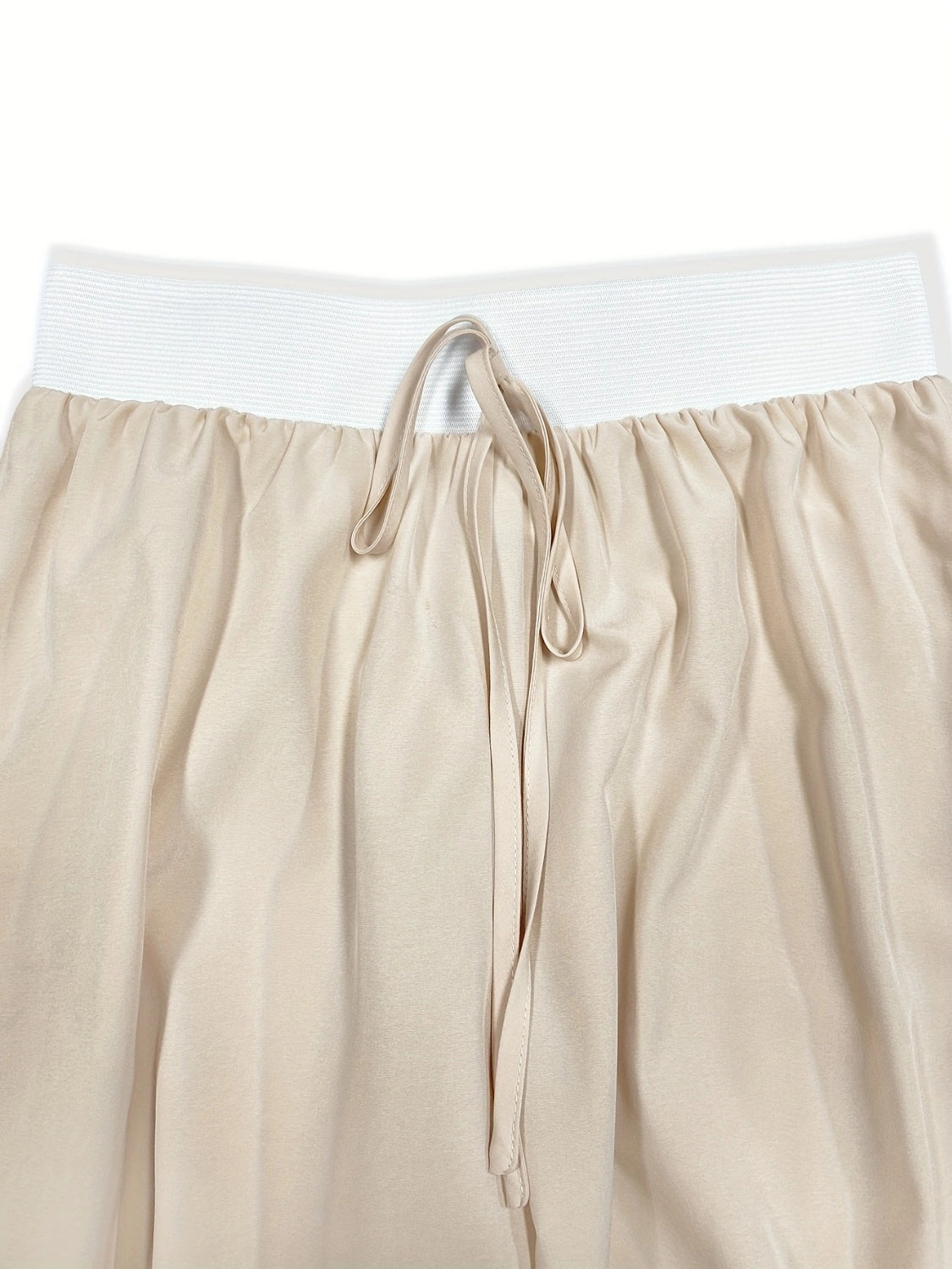 Beige wide-leg pants with elastic waistband and drawstring detail