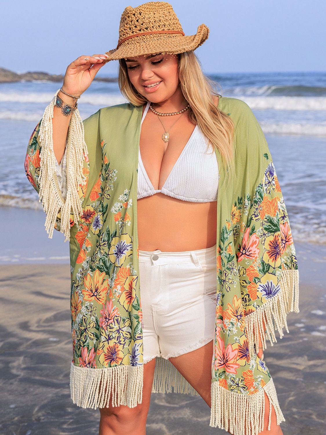 Sage floral print kimono cover-up with fringe details and wide sleeves.
