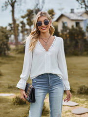 White textured blouse with lace trim neckline and cuffs