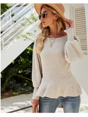 Cream ribbed knit peplum top with balloon sleeves and a scoop neck.