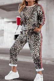 Leopard print joggers with red and white side stripes and drawstring waist.