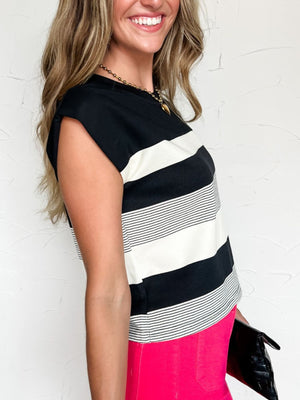 Chic black and white striped cap sleeve t-shirt with crew neck.