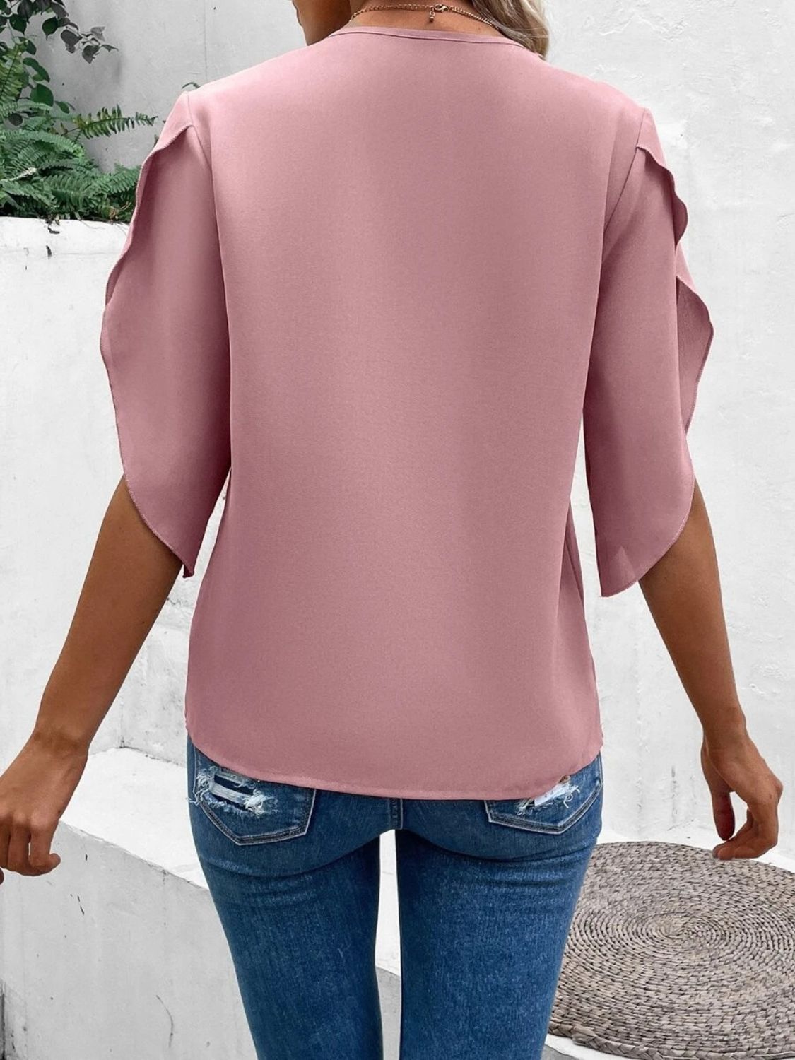 Dusty pink flutter sleeve blouse with scalloped lace trim detail.