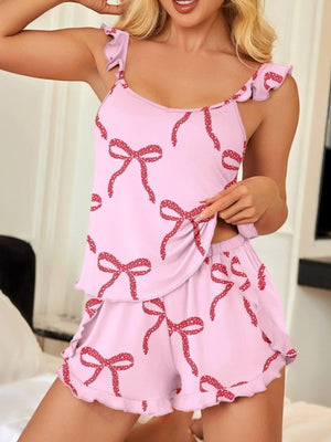 Blush pink cami and shorts pajama set with red bow print and ruffled trim.