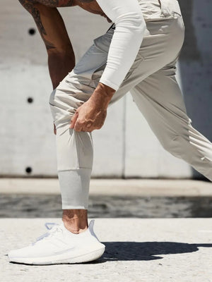 Technical cargo joggers in mocha with ribbed cuffs and pockets, shown on a man.