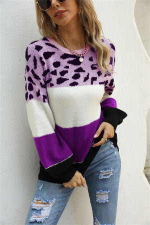 Leopard patchwork knit sweater with balloon sleeves in purple, white, and black colorblock.