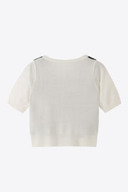 White argyle knit cropped cardigan with short sleeves and ribbed hem.