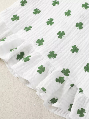 White cotton baby set with green shamrock print and ruffled trim.