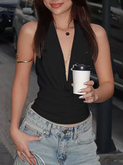 Black halter ruched cami top with deep V-neck, styled with jeans.