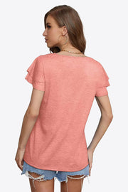 Peach tiered sleeve blouse with a textured knit fabric.