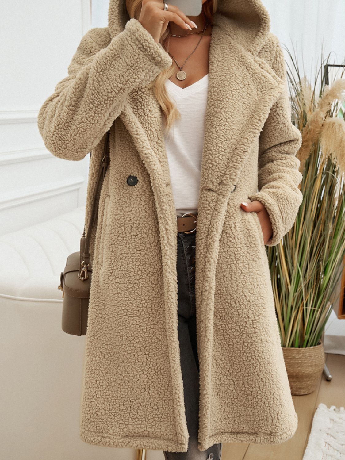 Camel teddy hooded cocoon coat with double-breasted closure and lapel collar.