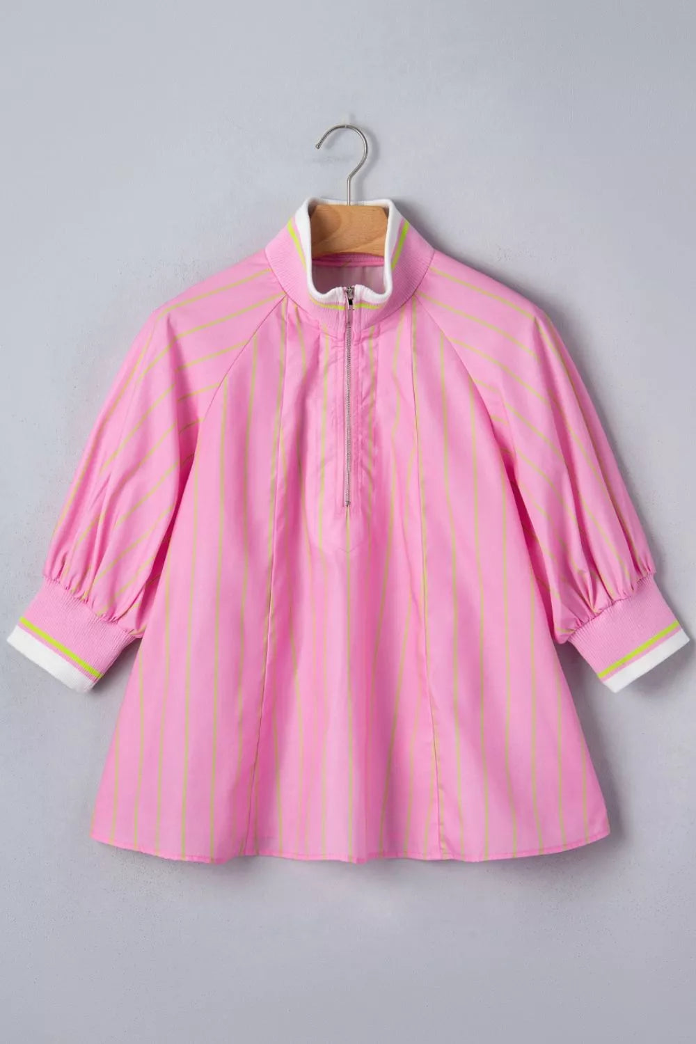 Pink striped half-zip polo shirt with white collar and cuffs